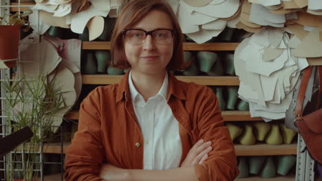 Portrait-of-Happy-Female-Shoemaker-in-Workshop